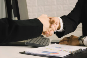 Securing the deal with a handshake after finally getting loan approval