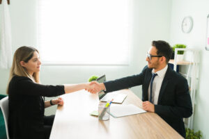 A person shaking hands with a lender, symbolizing a successful loan agreement