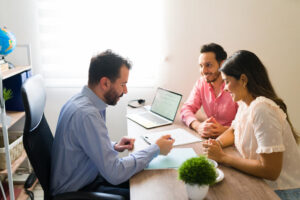 Reviewing documents for personal loan approval with a happy couple.