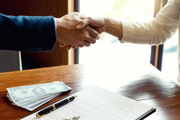 A handshake between lender and borrower, symbolizing industrial loan agreement