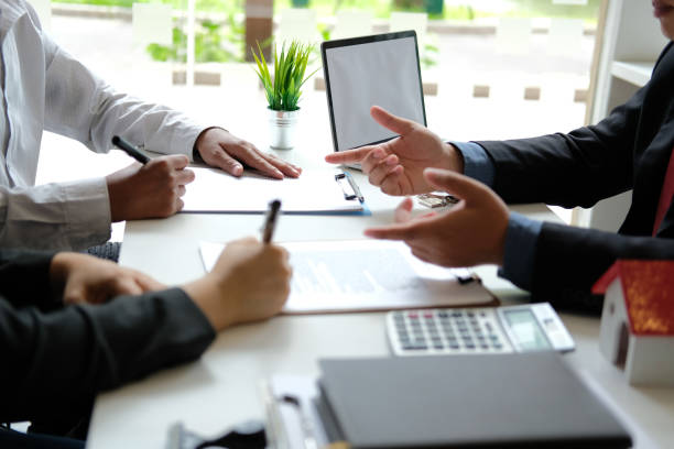Business professionals discussing financial documents for fix and flip loans