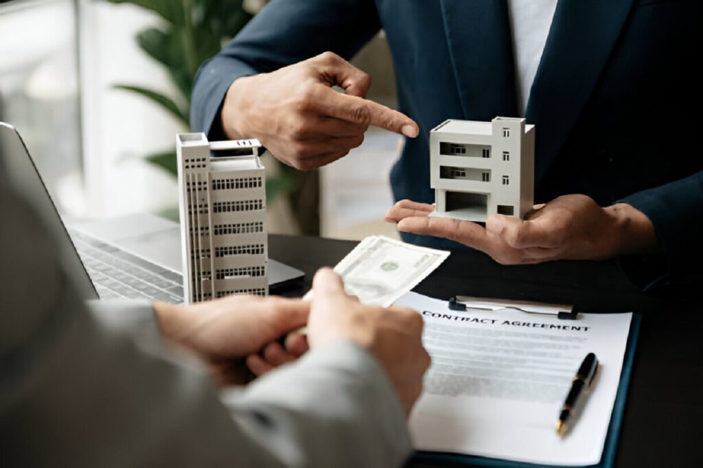 Office property loan consultation with a model building and cash exchange
