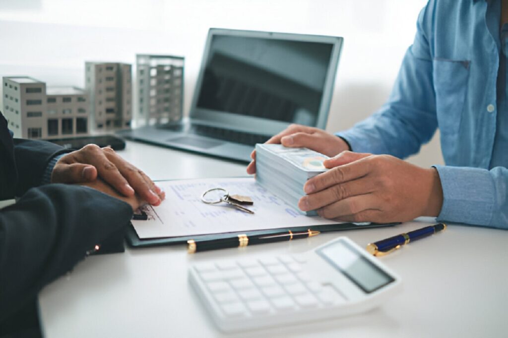 Multi-family property loan service consultation with paperwork and cash