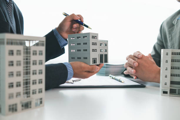Business discussion about mixed-use property loan with building model