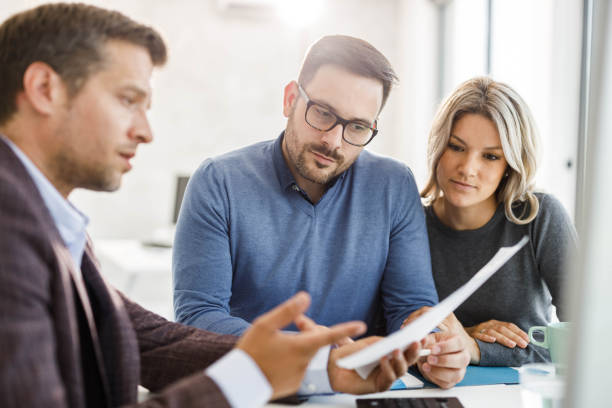 A couple discussing commercial loan options with a financial advisor