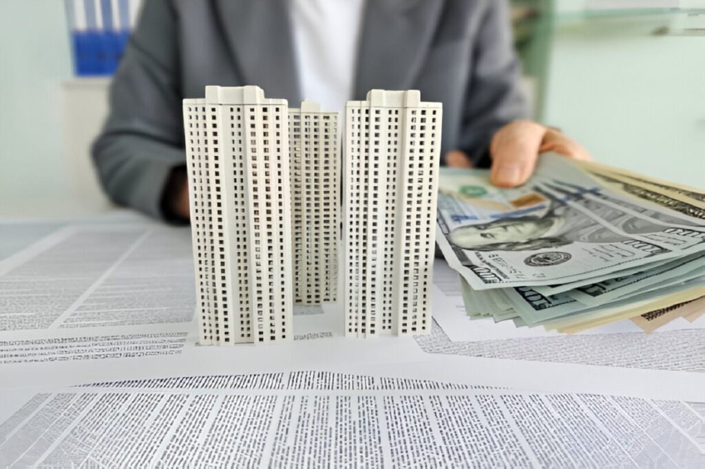 Model of mixed-use property with cash representing a property loan