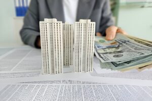 Model of mixed-use property with cash representing a property loan