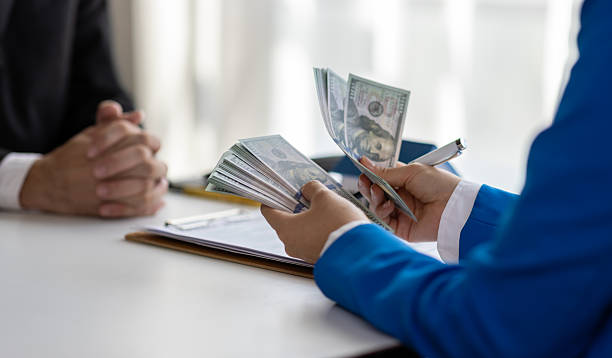 Hand exchanging money during land loan negotiation and agreement