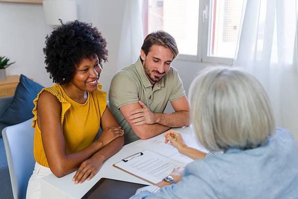 Couple consulting with advisor about rehab loan options and paperwork