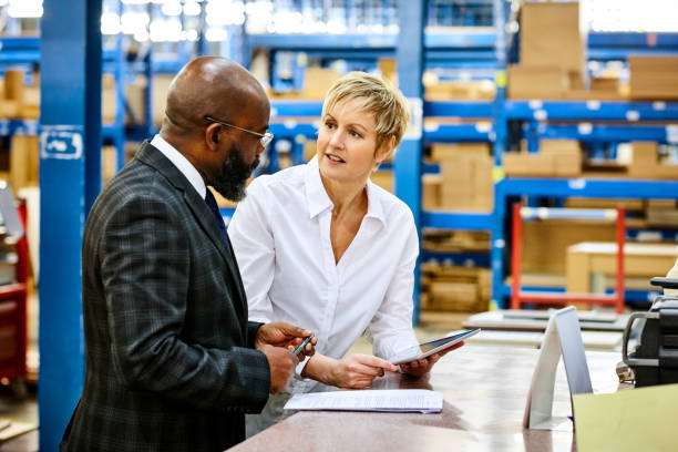 Business conversation about industrial property loan in warehouse setting