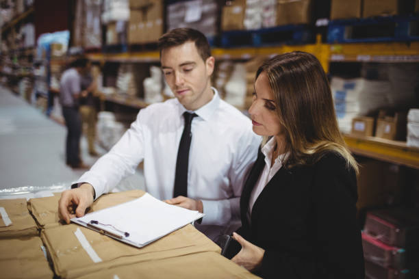Client consulting with advisor about warehouse property loan options and paperwork