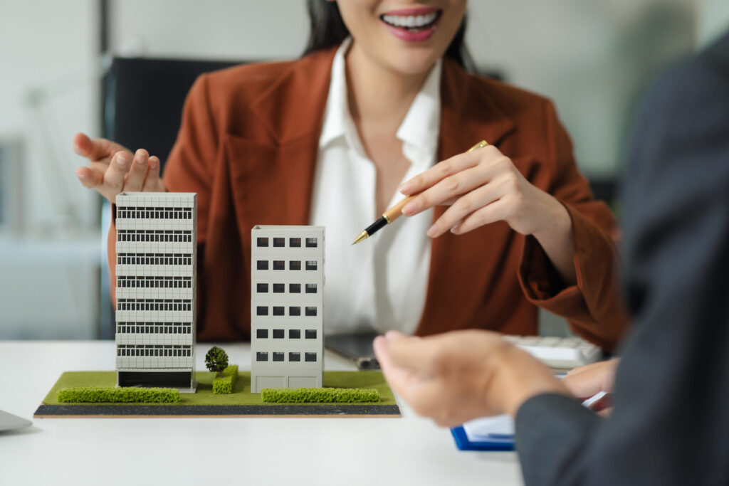 Client reviewing commercial property models while comparing land lenders