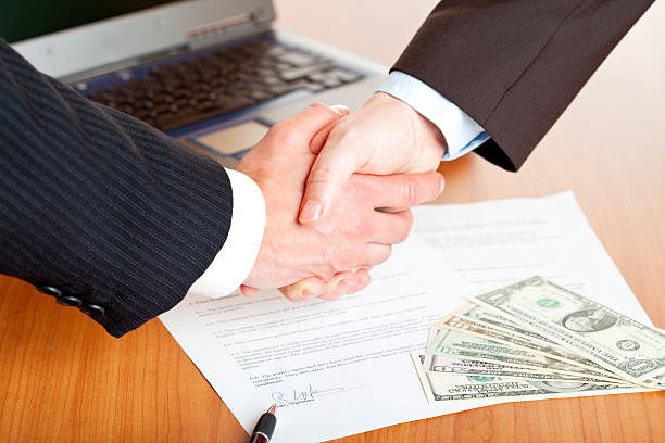 Foreclosure bailout lender and client shaking hands after loan deal