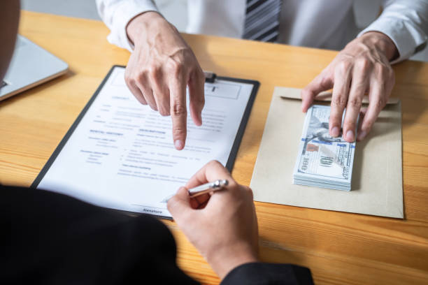 Fix and flip loan lenders sign a contract and exchange cash for the loan