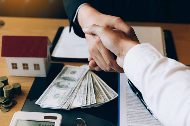 Client and hard money lenders shake hands after the loan agreement