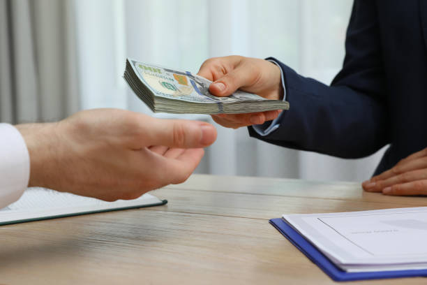 Commercial hard money lender handing over cash during a business deal