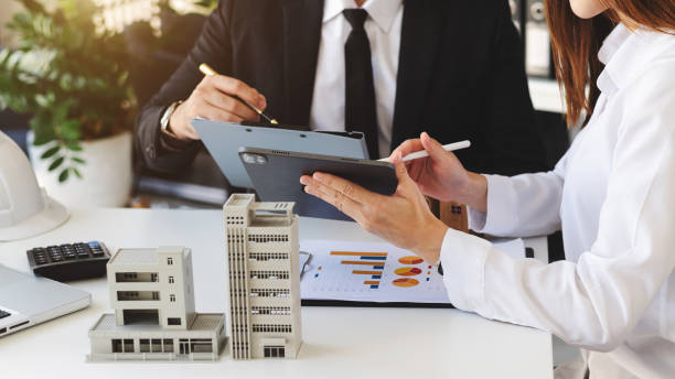 Business discussion on industrial property loan with a model building