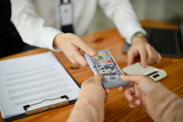 Fix and flip loan lenders handing over money after agreement signing