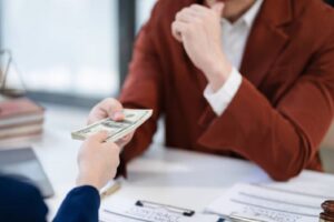 Industrial real estate lenders handing cash over during a meeting