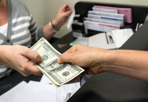 Commercial hard money lender providing funds to a customer in the office