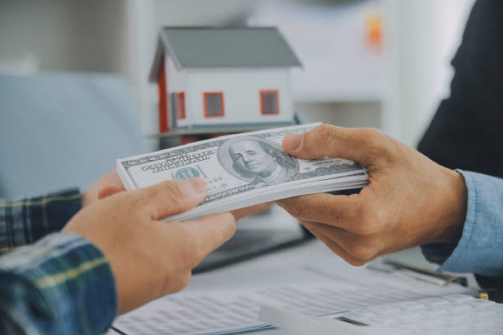 Close-up of hard money lenders giving money for a property transaction