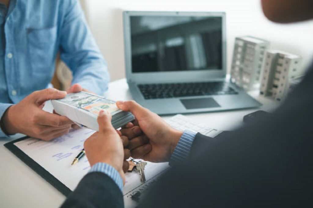 Retail property loan lender exchanging cash in a business deal
