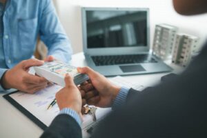 Retail property loan lender exchanging cash in a business deal