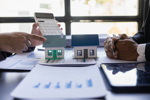 Professionals analyzing housing models during land loan lender meeting