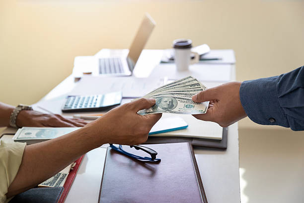 Client receiving funds for a loan for office space in a workplace setting
