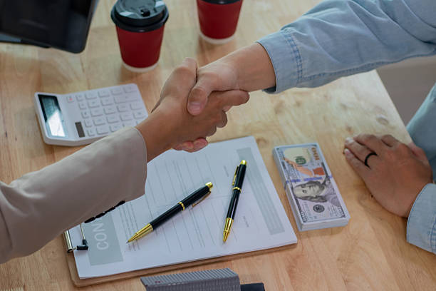 Retail property loan lender shaking hands on financial deal
