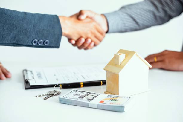 Private home loan agreement finalized with handshake and property model