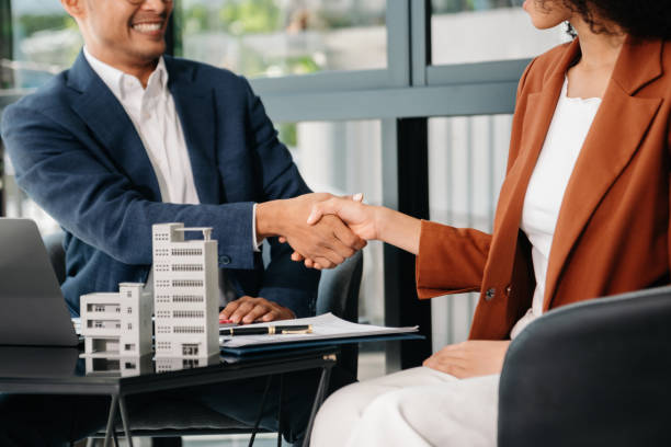 Real estate asset based loan approval marked by professional handshake