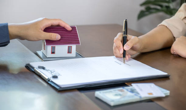 Private lender reviewing home loan documents with borrower