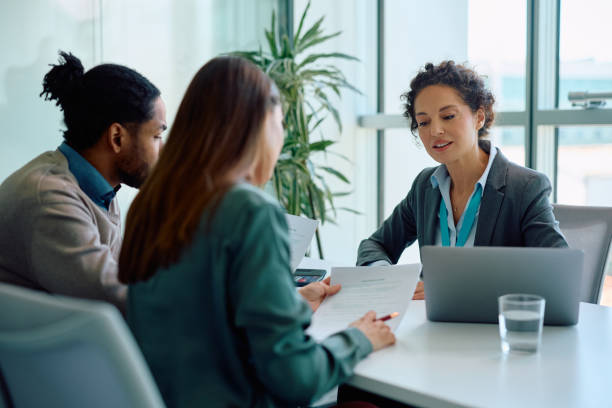 Lender reviewing proof of funds documents with real estate buyers