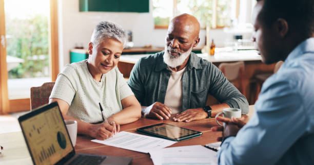 Couple reviewing and signing no income verification loan paperwork