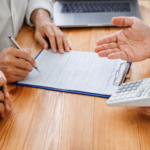 People Discussing private loan terms with calculator and forms
