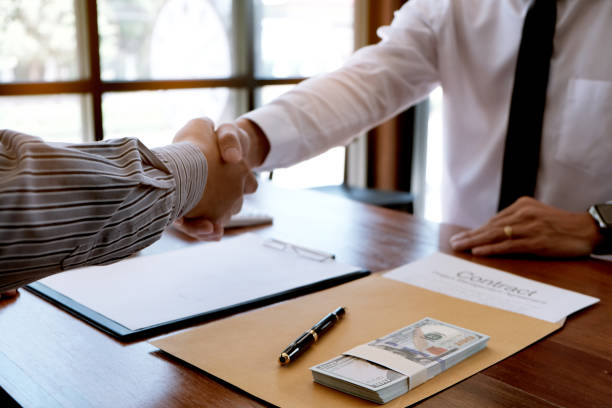 Finalizing land loan deal with paperwork and cash