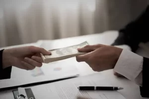 Cash being handed over in a no income verification loan agreement