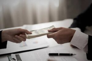 Private lender handing cash for no income loan deal