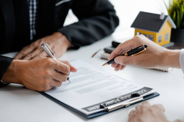 Land loan agreement being signed by two people