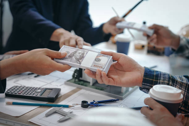 Professionals handling money during a bridge loan agreement