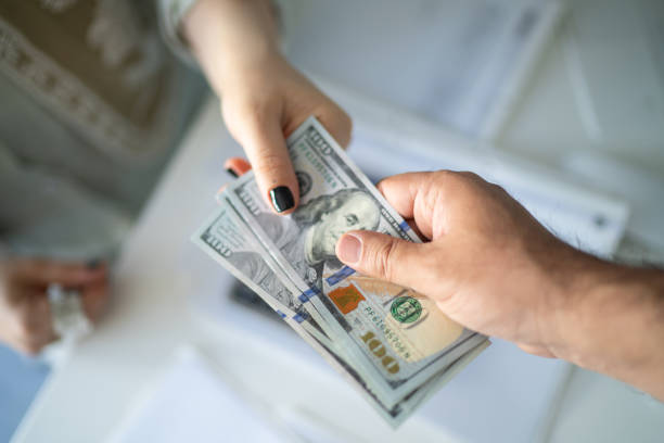 Private money lender handing cash to business borrower