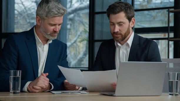 Private lenders evaluating business financing paperwork together