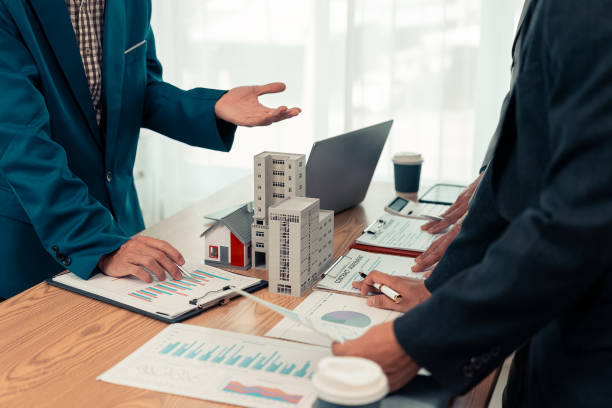 Private lenders reviewing real estate loan terms and property models
