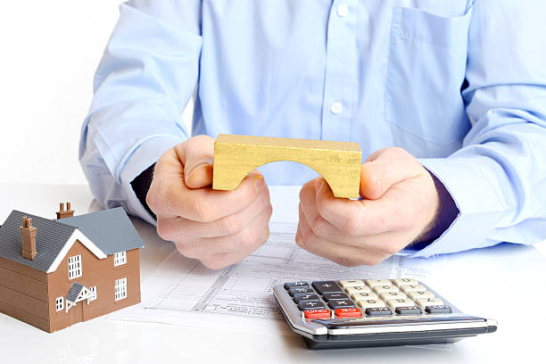 Professional discussing bridge loans with model and documents