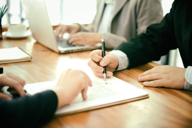 Investor signing proof of funds letter at business meeting